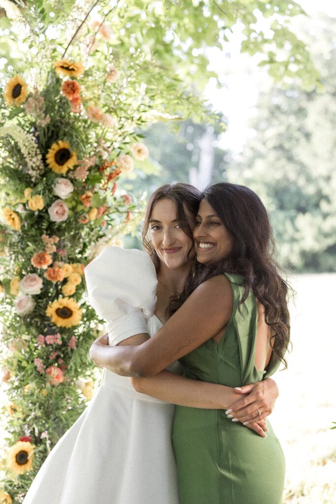 La mariée et sa demoiselle d'honneur devant l'arche de cérémonie